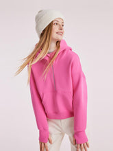 A lady wears a pink hoodie on Thanksgiving day.
